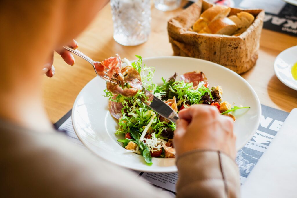 woman eating healthy meal while struggling with weight loss after 40
